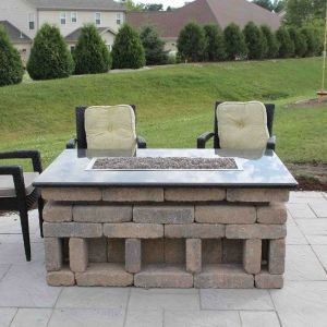 Stone countertop on outdoor fireplace in backyard