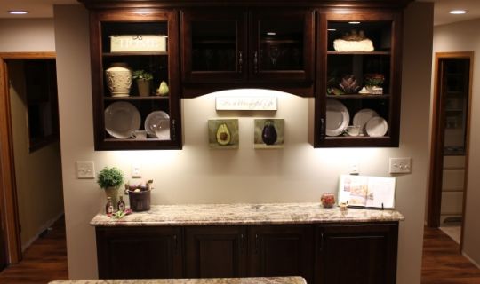 Dark Stained Cabinets and Light Stone Countertops